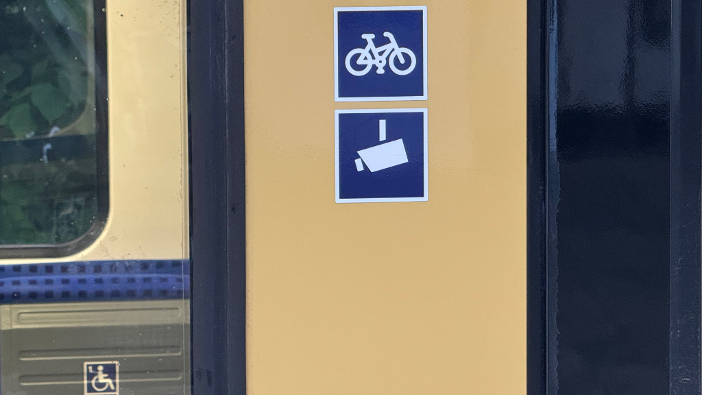 Sie sehen das Videoüberwachungssymbol an einem Berliner S-Bahn-Wagen.