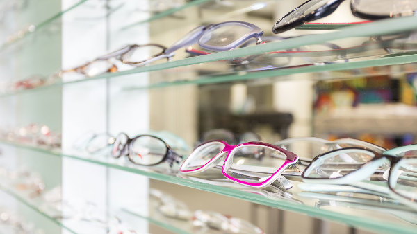 Sie sehen Glasregale mit Brillen, wie beim Optiker.