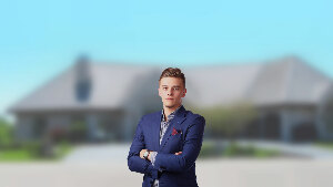Sie sehen einen Immobilienmakler vor der unscharfen Darstellung eines Hauses.